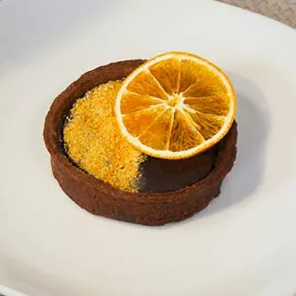 Dehydrated orange slice on chocolate dessert Dehydrated orange slice on chocolate dessert